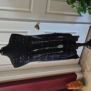 Black and white top or swim suit cover up.